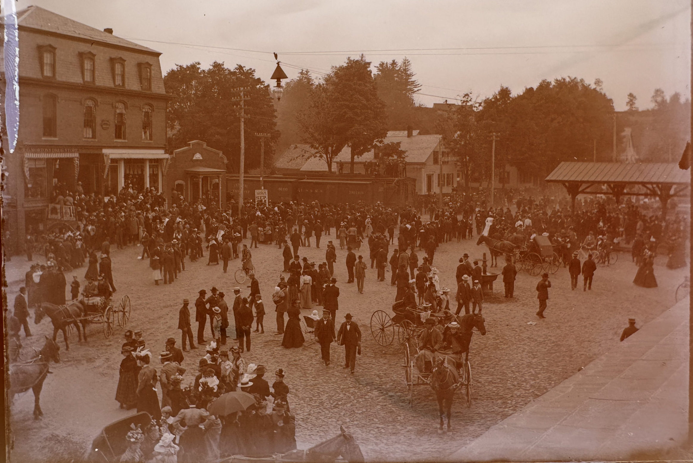 sepia-toned old photos showing people gathered in a street.